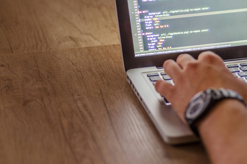 pexels-photo-574069-574069 Close-up of a person coding on a laptop, showcasing web development and programming concepts.
