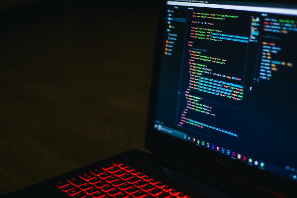 pexels-photo-943096-943096 Red backlit keyboard and code on laptop screen create a tech-focused ambiance.